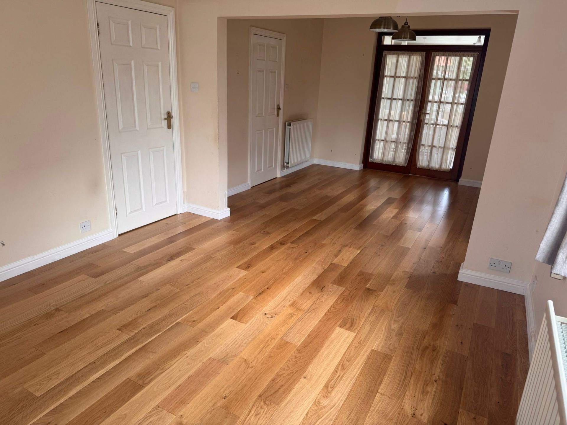 Solid oak flooring fitted through a dining room — a recent Hallmark Floors installation