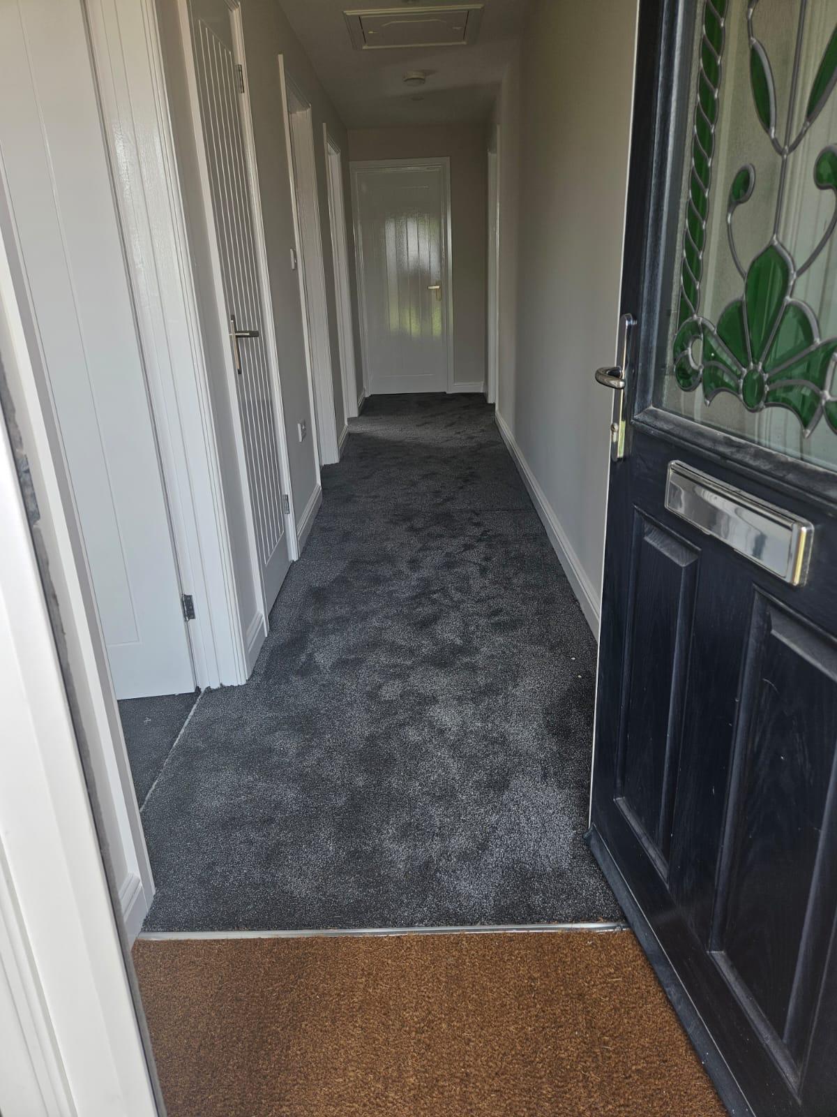 Deep grey carpet hallway