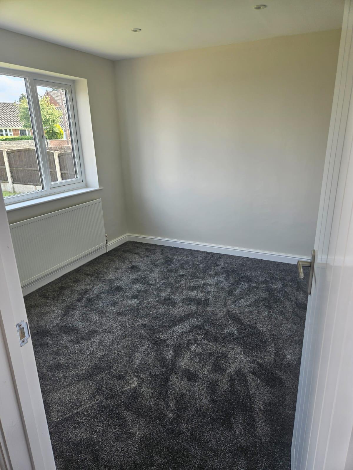 Grey bedroom carpet with natural light